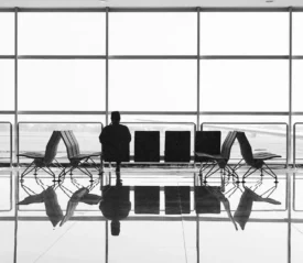 Man sitting in airport looking out window