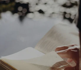 Hand turning page in Bible