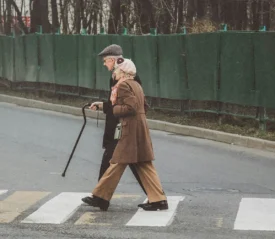 Elderly couple crossing the street on crosswalk
