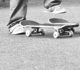 Two legs lifted above 2 skateboards