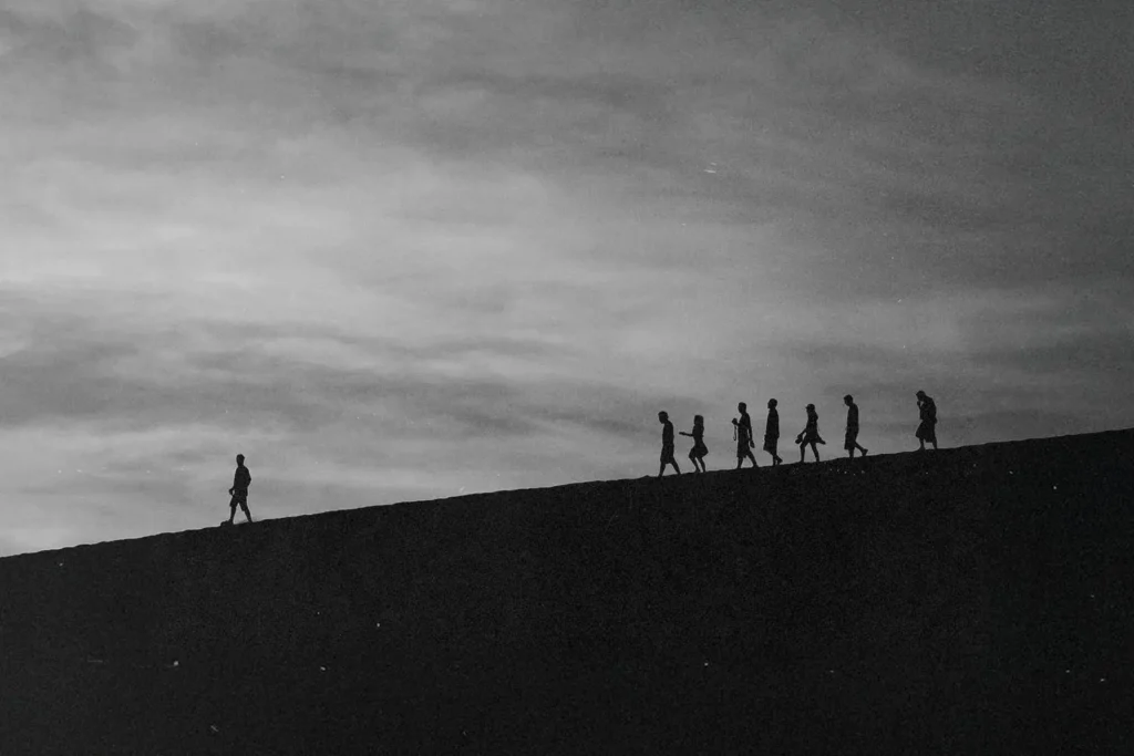 Person walking ahead leading a group of people