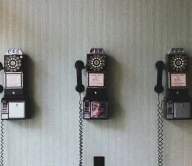 3 black wall mounted rotary dial corded telephones