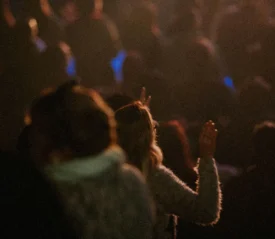 crowd with hands raised in worship