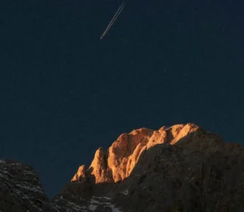 plane in the sky over a mountain
