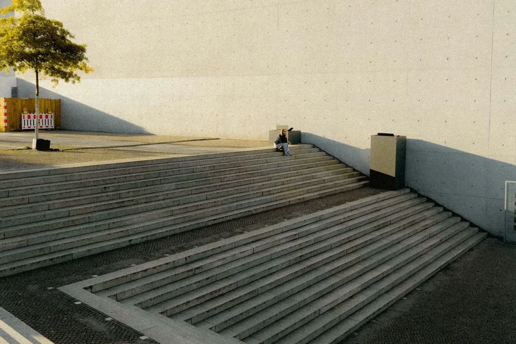 woman sitting outside on concrete steps