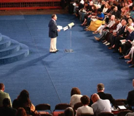 Kenneth Copeland standing at the podium talking to an audience