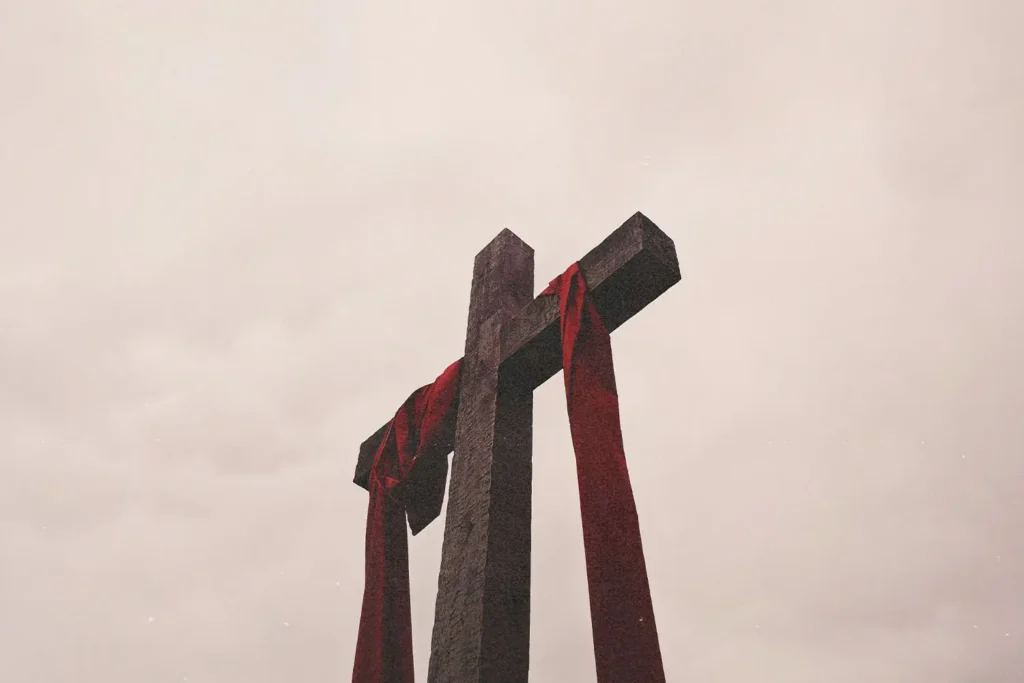 Ground view of wooden cross with red cloth draped across
