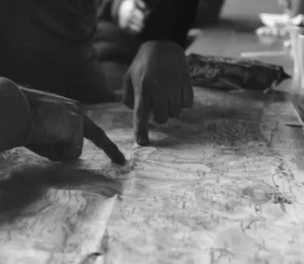 two hands pointing to a map