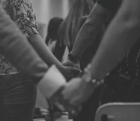 Line of people holding hands