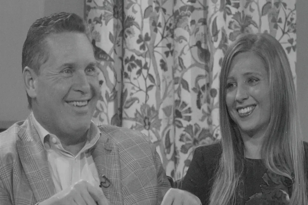 Randy Roberts and woman sitting with a smile