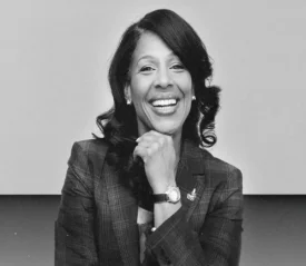 Tamaira Sandifer posing with her hand under her chin and smiling