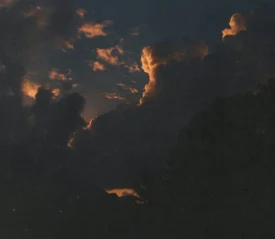 dark sky with sun trying to shine through