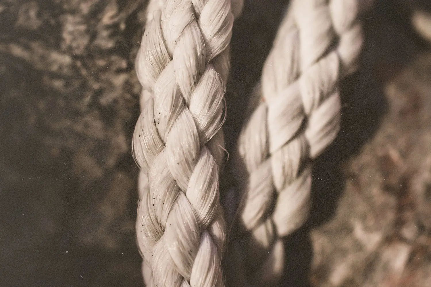 Two pieces of braided fabric resting on a wooden background