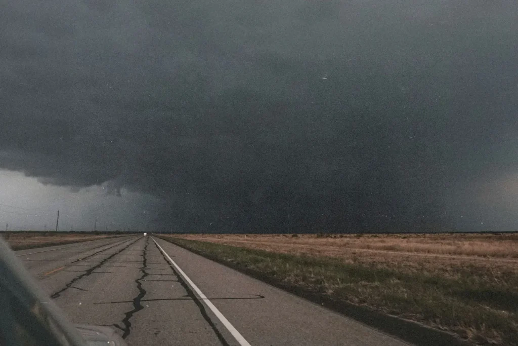 Open road with a tornado in the distance