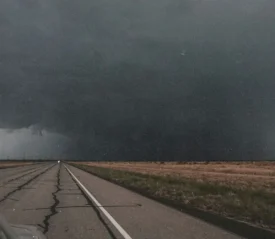 Open road with a tornado in the distance