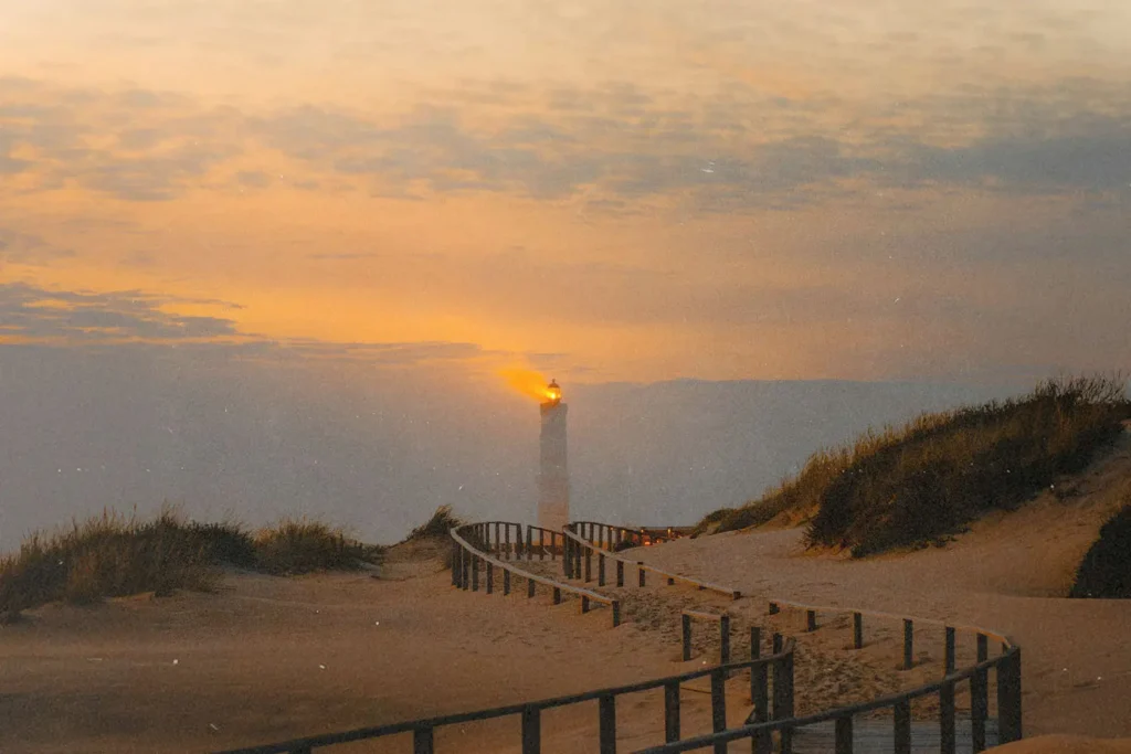 lighthouse at the end of a boardwalk