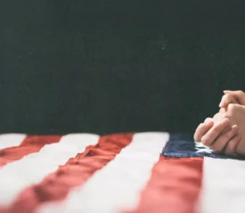 praying hands on USA flag