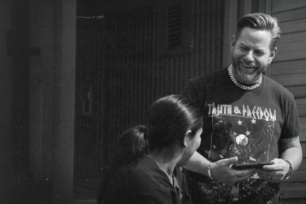 Riley Stephenson smiling and evangelizing to a woman