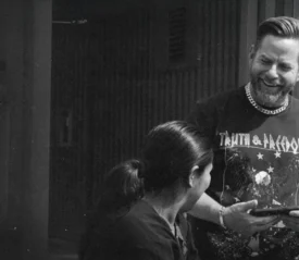 Riley Stephenson smiling and evangelizing to a woman