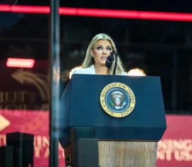 Erika Kirk speaks in front of the presidential seal at Charlie Kirk's memorial service.