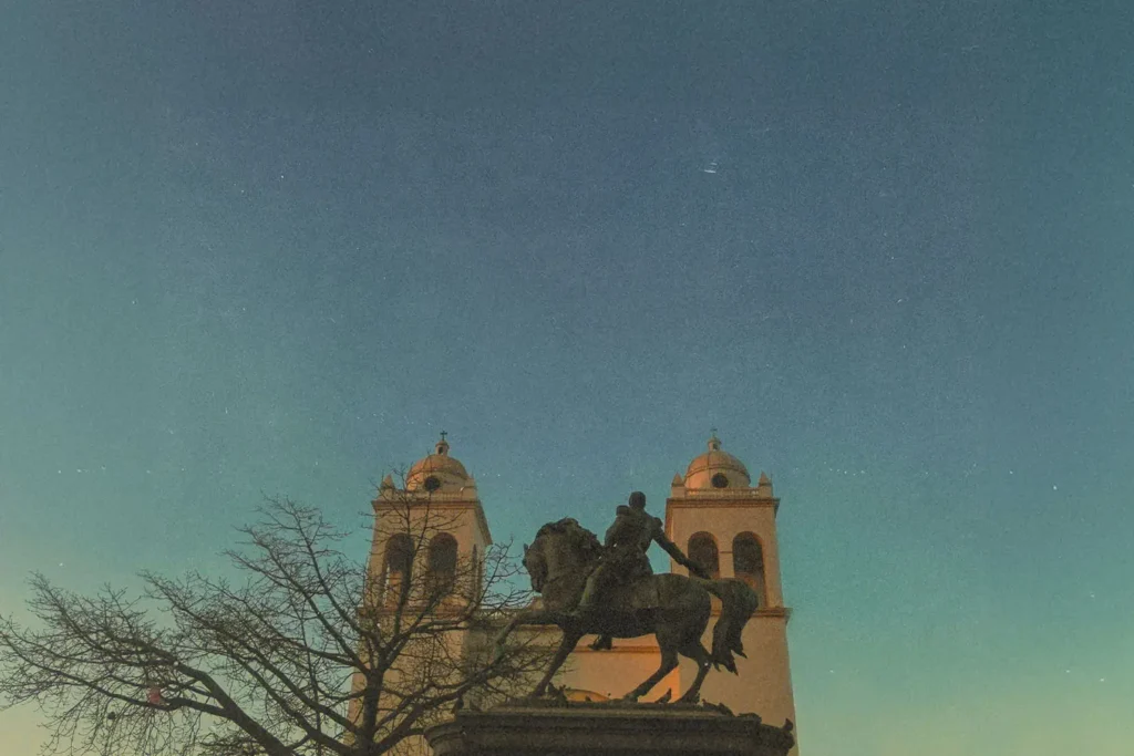 statue of guy on a horse in front of building