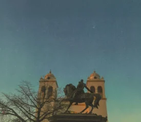 statue of guy on a horse in front of building