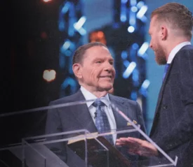 Kenneth Copeland and Johnathan on stage at the Omaha Victory Campaign