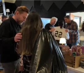 An adult man prays for someone at a Kerrville Christmas chapel in Central Texas