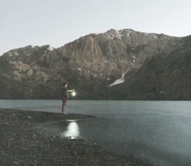 Explore how a Spirit Guide leads believers under the Holy Spirit and God’s Authority, symbolized by a serene mountain lake and quiet reflection.