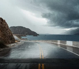 A stormy coastal road beneath dark clouds symbolizes enforcing the authority of God to speak peace and protection when life’s circumstances rise against you.