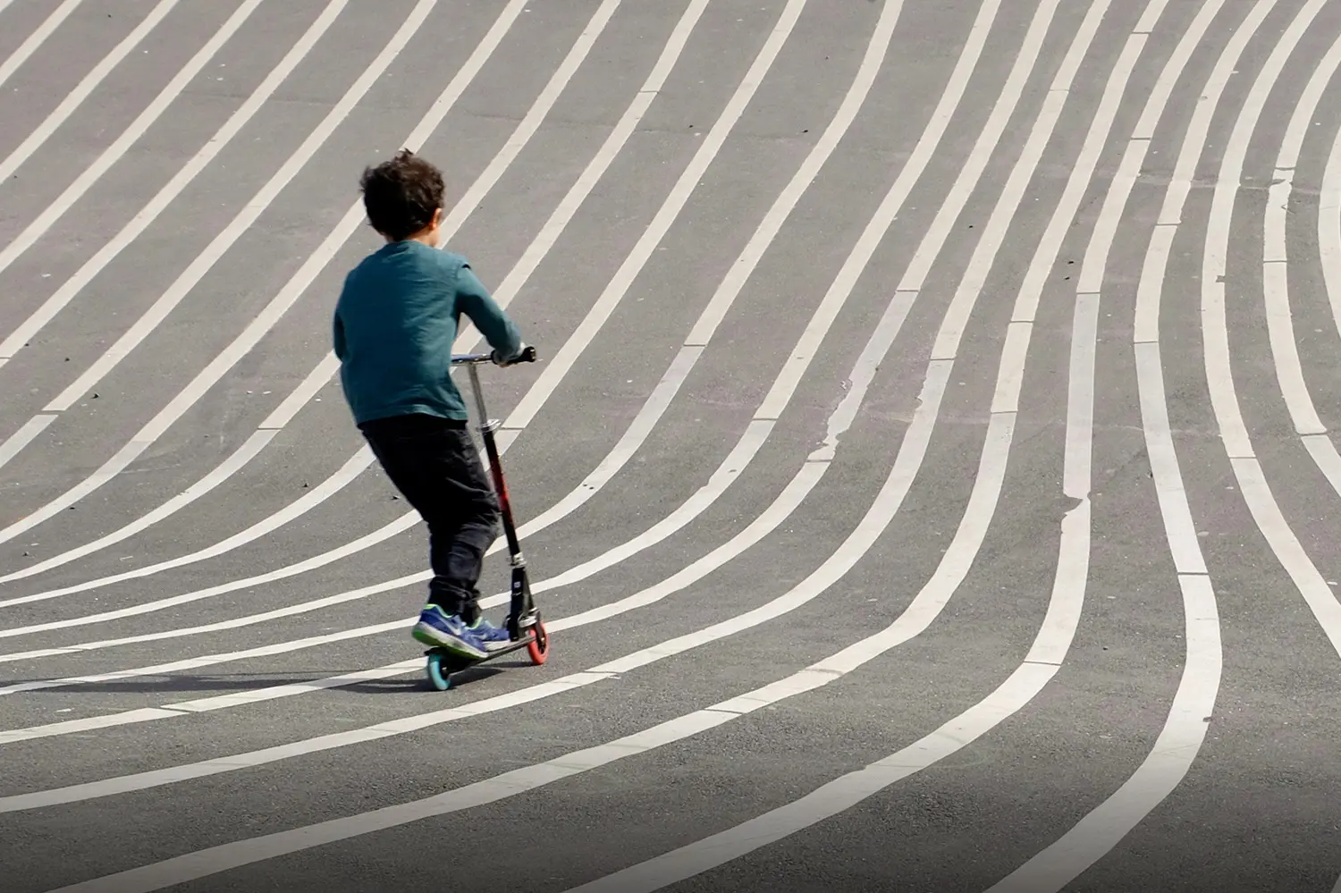 Child riding a scooter on striped pavement, symbolizing how faith helps prepare for the future with guidance and hope.