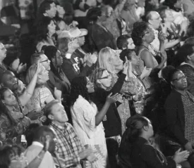 black and white photo of people praising