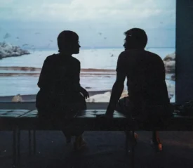 Two people talking on a patio