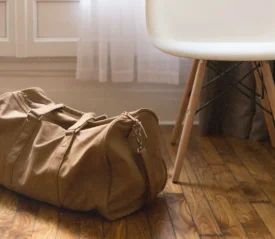 duffle bag sitting on floor next to chair
