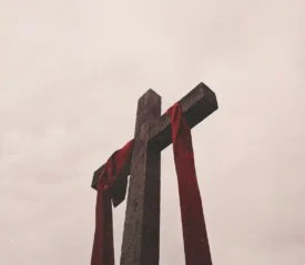 Ground view of wooden cross with red cloth draped across
