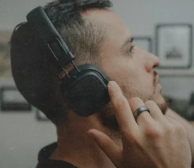 Person wearing headphones, symbolizing listening for God’s voice through prayer, Scripture, and spiritual awareness in a growing relationship with God