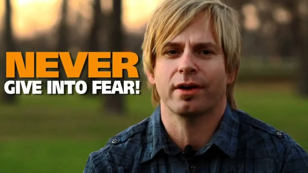 Video thumbnail: man outdoors speaking, with bold 'NEVER GIVE INTO FEAR!' text overlay.