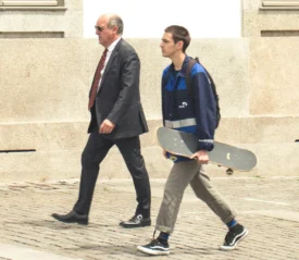 Two guys walking on the street.