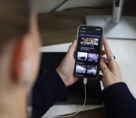 Looking over a young lady's shoulder at a mobile app being used.