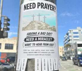 Need Prayer flyer with tear-away phone numbers attached to a pole.
