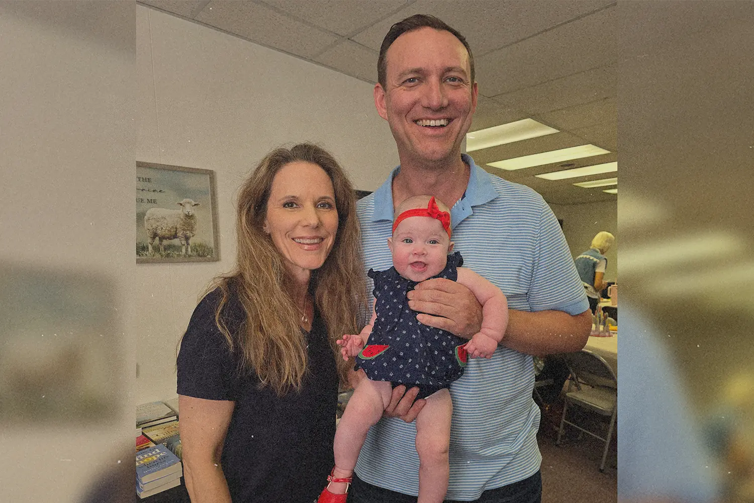A couple holding their baby.