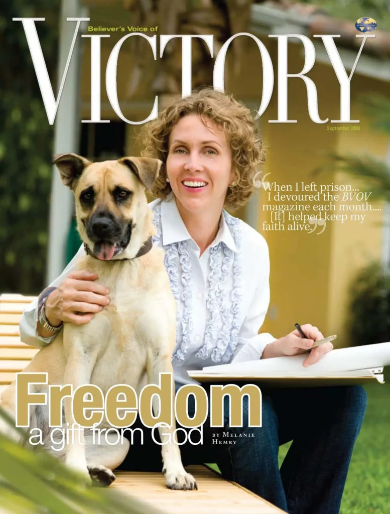 A magazine cover titled “VICTORY” featuring two individuals seated outside on a bench with a dog, along with the headline “Freedom: A Gift From God.”