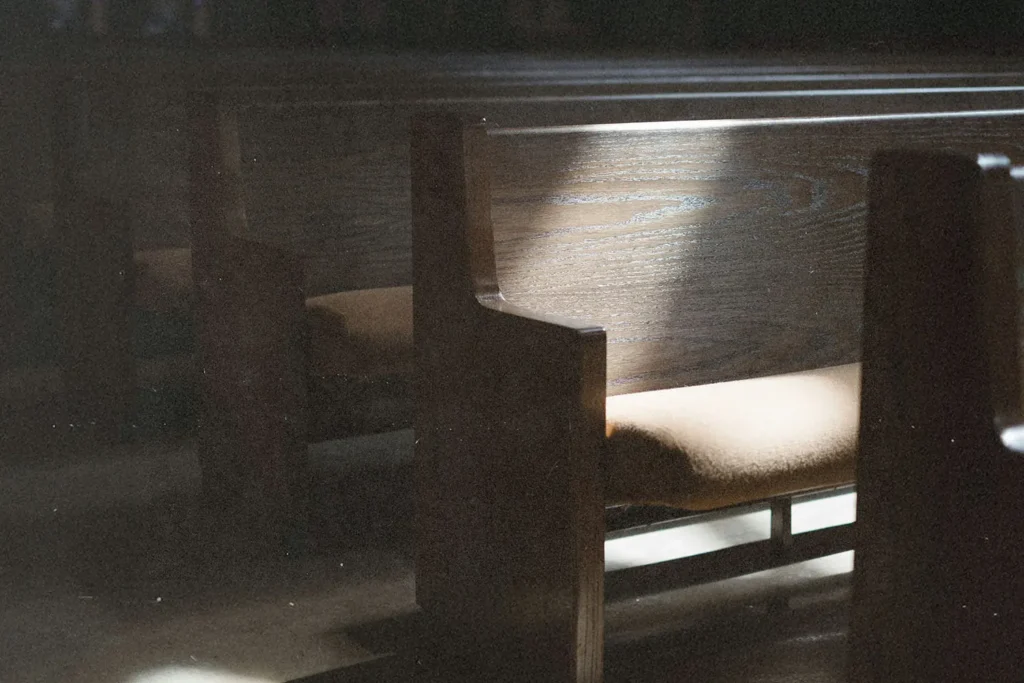 Sunlight illuminating wooden church pews in a quiet sanctuary