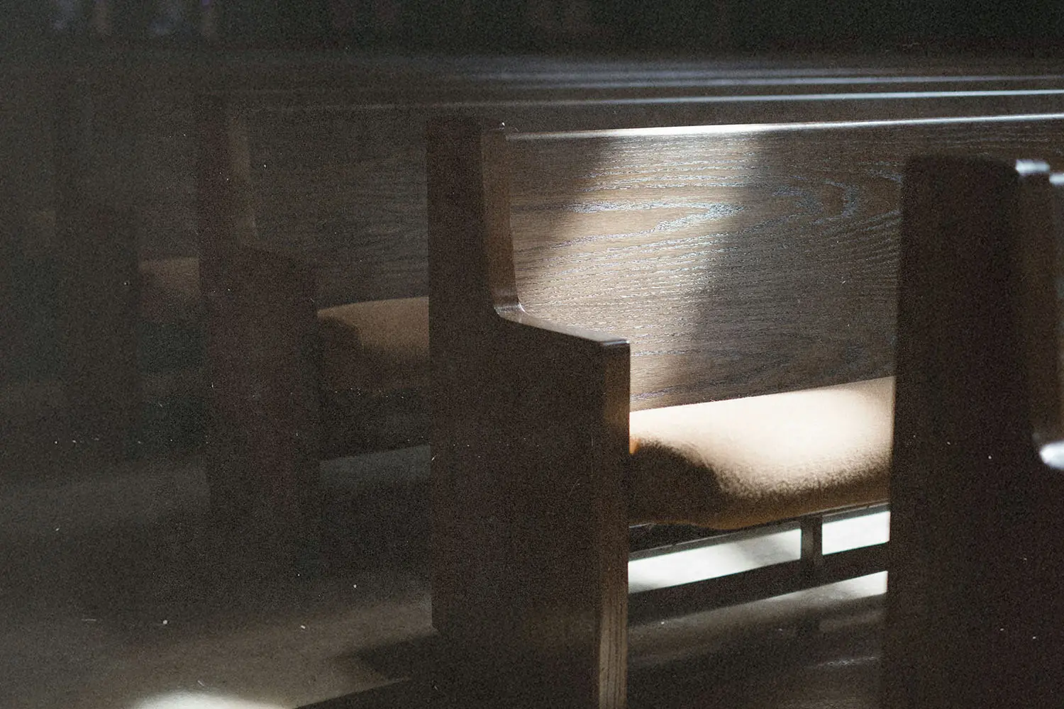 Sunlight illuminating wooden church pews in a quiet sanctuary