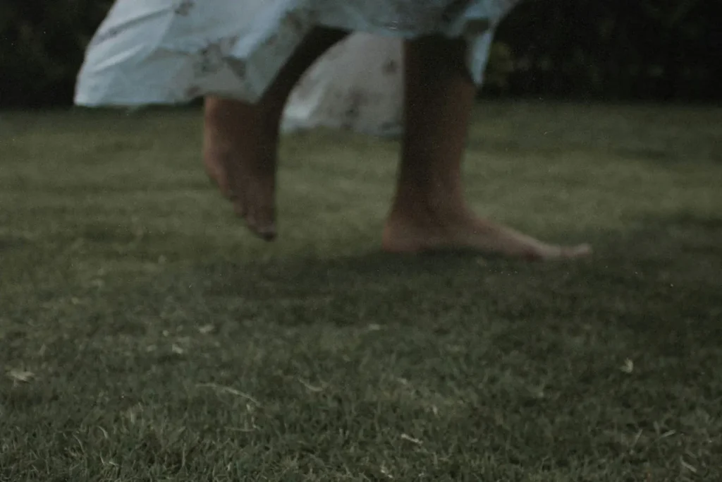 Close up of feet running on grass