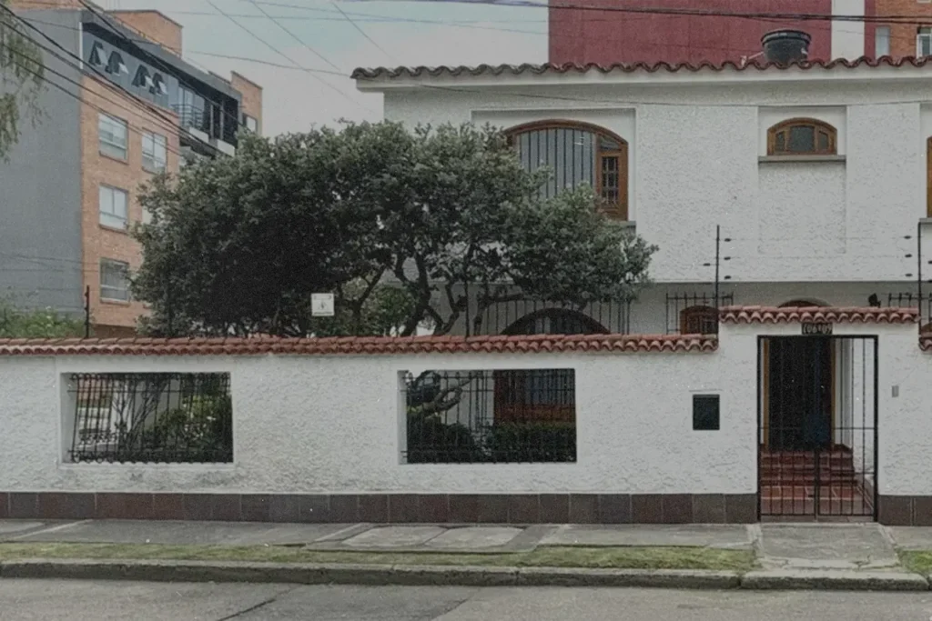 A Spanish style office building with a tree in the courtyard.