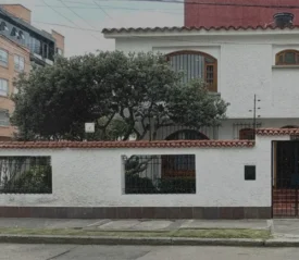 A Spanish style office building with a tree in the courtyard.
