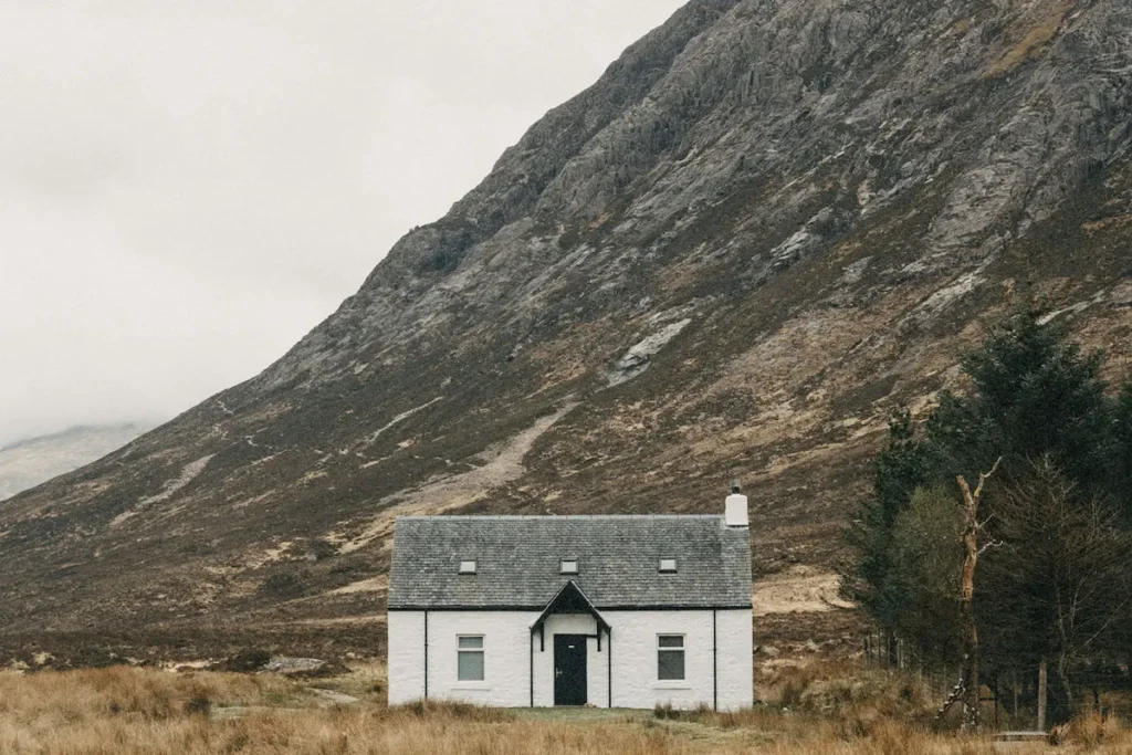 A remote house on a cloudy day, representing a safe place hidden from the storms of life.