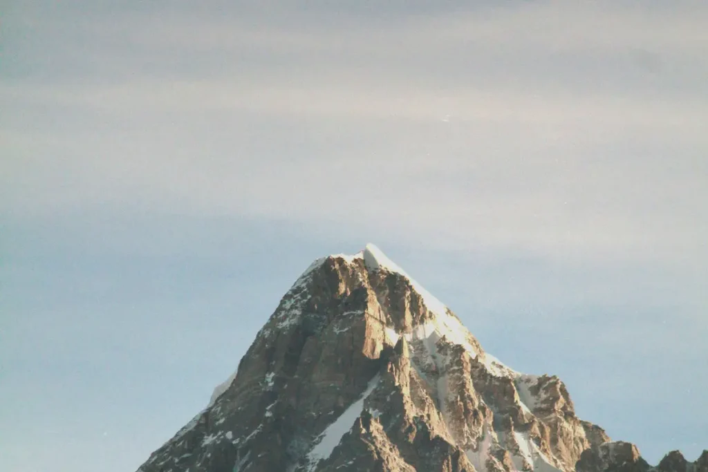A mountain peak against a bright blue sky