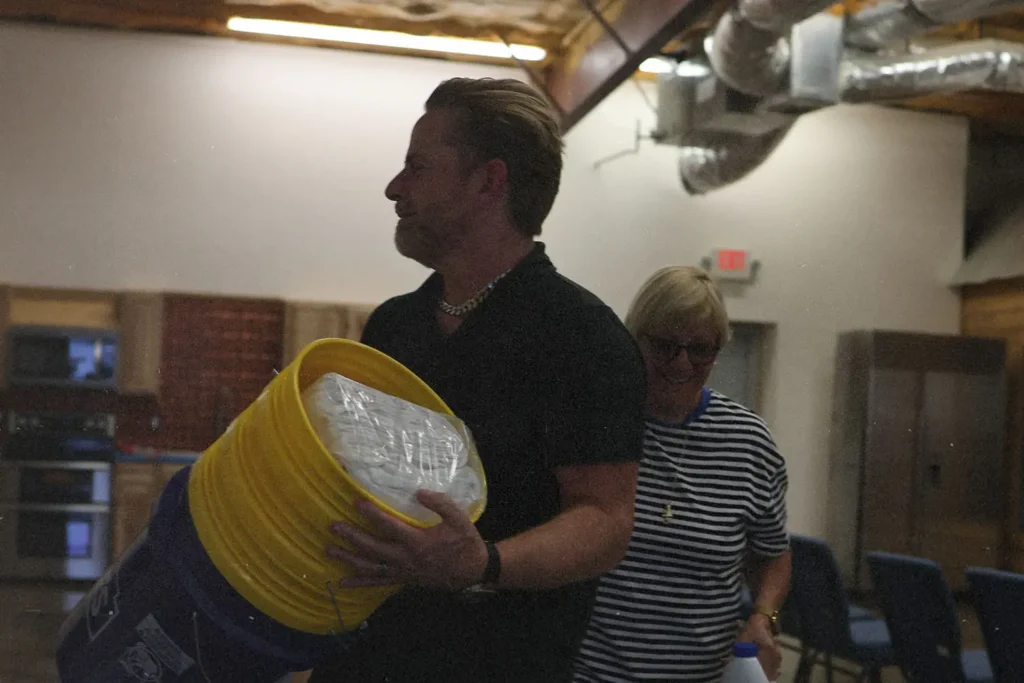 Riley Stephenson carrying a stack of buckets